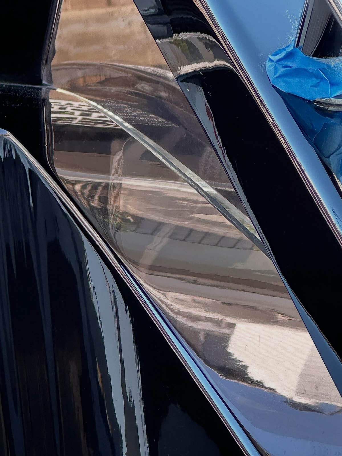 Mirror reflection on a freshly polished black yacht hull