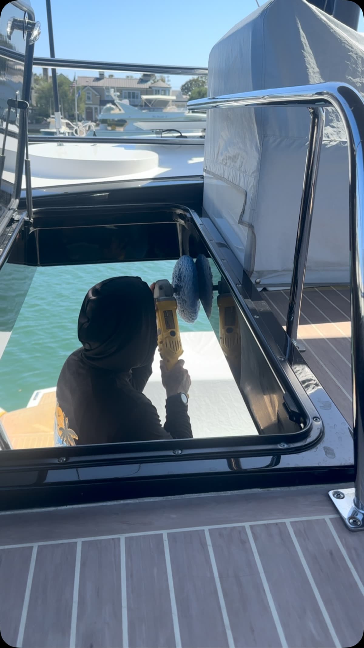Polishing inside an open hatch on deck